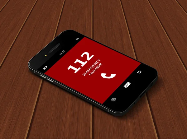Mobiltelefon med nödnumret 112 liggande på bordet — Stockfoto