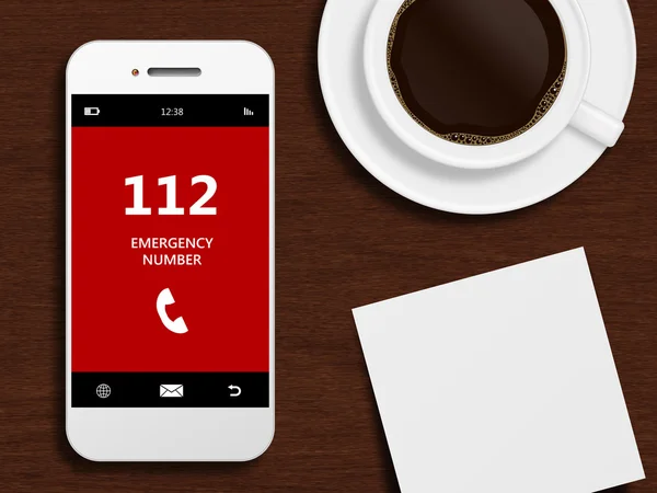 緊急電話番号 112 は、デスクの上に横たわると携帯電話 — ストック写真