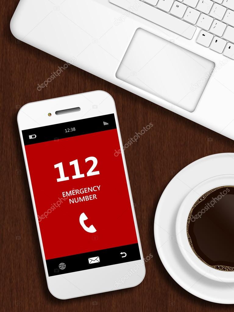 mobile phone with emergency number 112 lying on desk