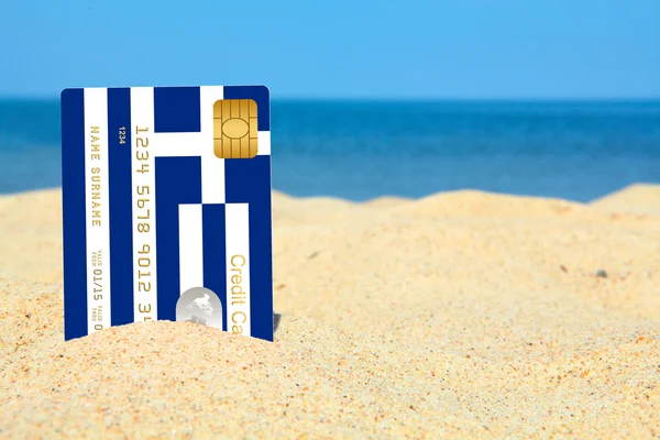 Griekse creditcard op het strand — Stockfoto