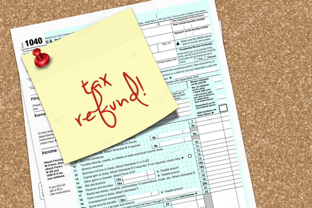 note with tax refund text and 1040 tax form pinned to pin board