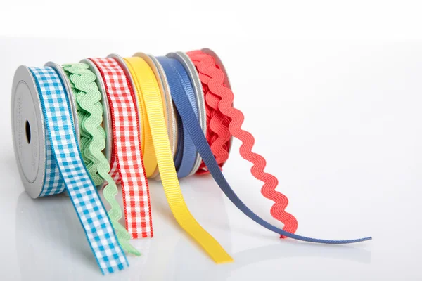 Colorful ribbon rolls on white — Stock Photo, Image