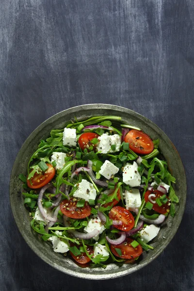 Salade met rucola, tomaat, kaas en rode ui Stockfoto