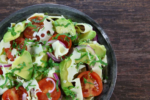 Salad with avocado, cheese, tomato and red onion — Stock Photo, Image