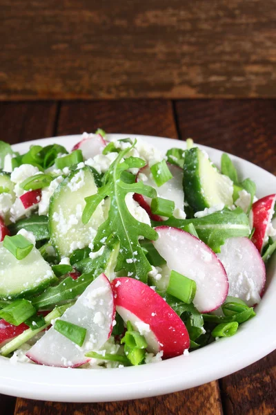 Salad with arugula, cucumber, cottage cheese and radish Stock Picture