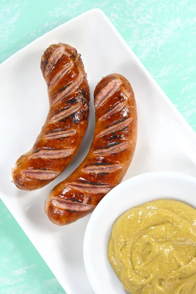 Fried sausage on white plate — Stock Photo, Image