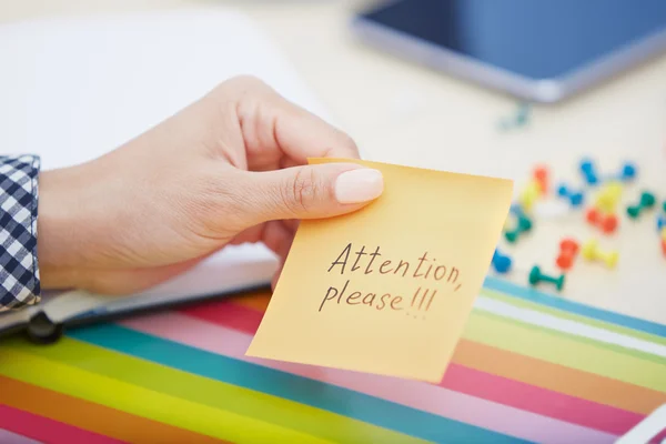 Attention please text on adhesive note — Stockfoto