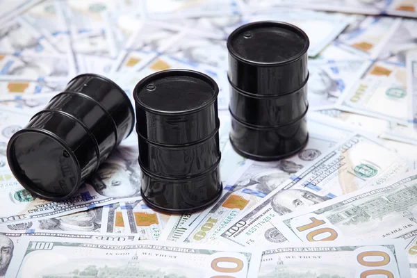 Oil drums on US dollars background — Stock Photo, Image