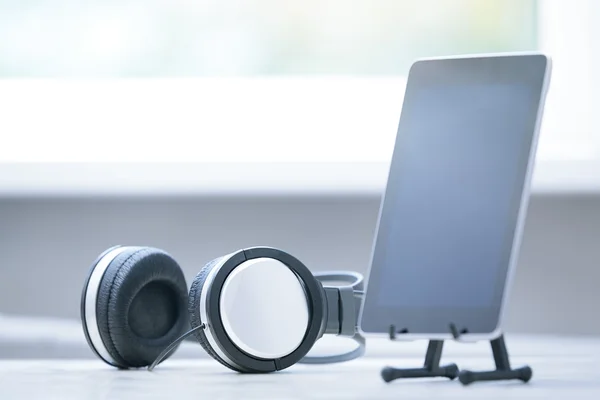 Headphones and digital tablet at office — Stock Photo, Image