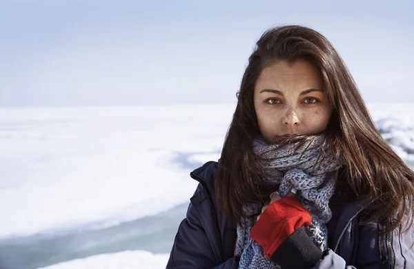 Young adult woman outdoors in icy landscape