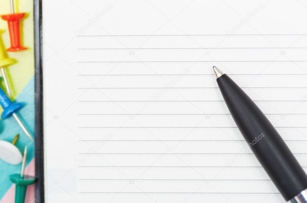 Notepad with pen and pushpins