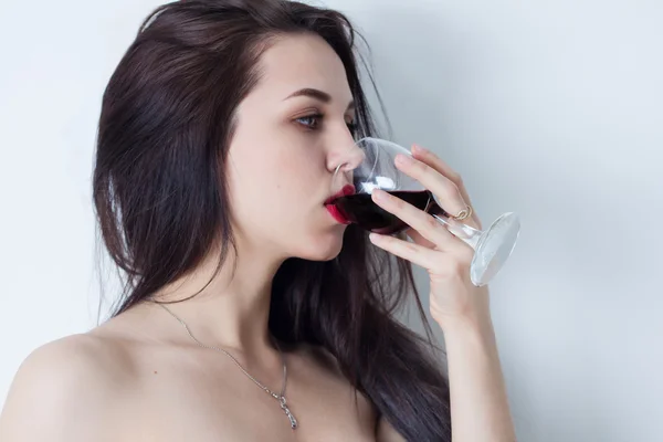 Beautiful woman with big eyes drinking red wine — Stock Photo, Image