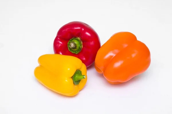 Three whole bell peppers of different colors — Stock Photo, Image