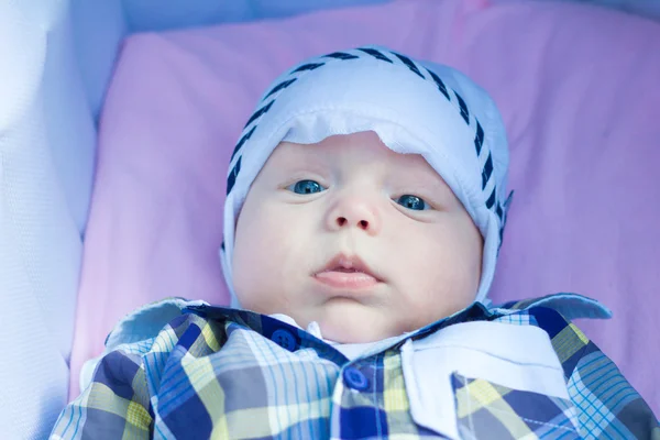 Six-month baby is lying in a stroller and looks around — Stock Photo, Image