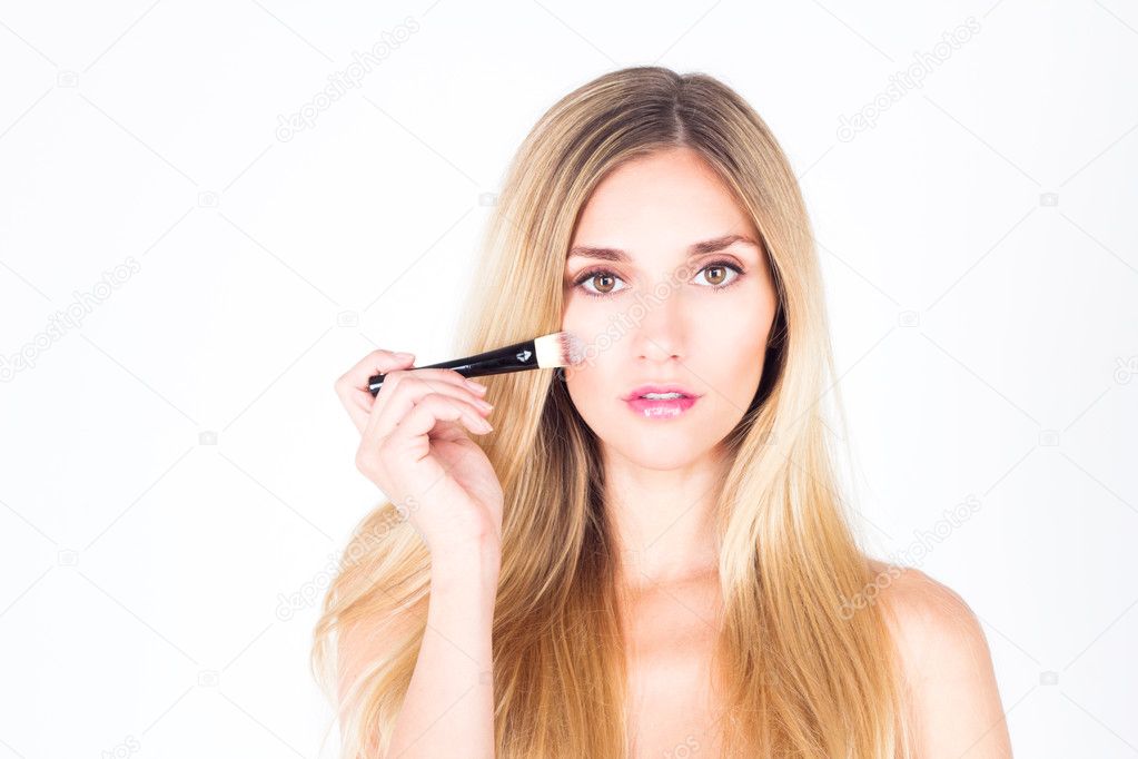 Woman with cosmetic brush for foundation. Make-up artist.