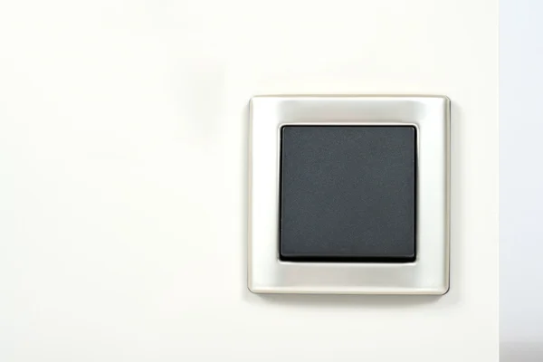Light switch with silver frame on the wall — Stock Photo, Image