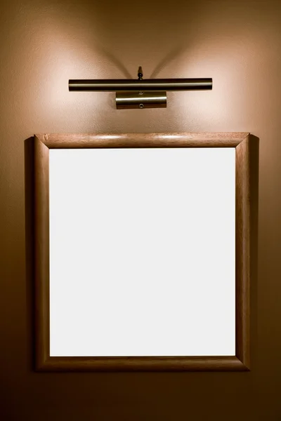 Picture frame illuminated by lamp on the wall — Stock Photo, Image