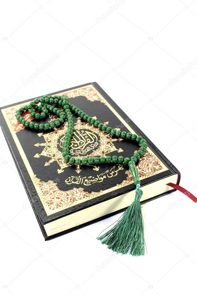 slammed Quran with green rosary