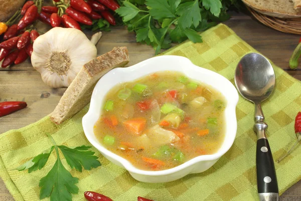 Chicken consomme with bread — Stock Photo, Image
