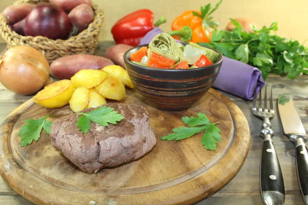 Ostrich steak with crispy baked potatoes and parsley — Stock Photo, Image