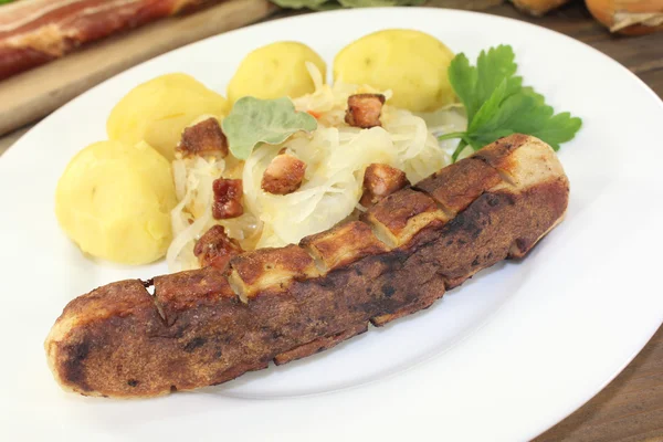 Brawurst and sauerkraut with bacon and laurel — Stock Photo, Image