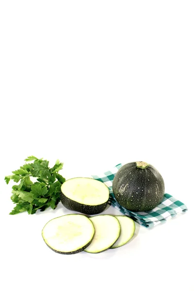 Rotund raw zucchini on a green napkin — Stock Photo, Image