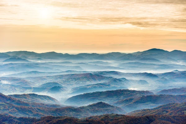 Ranges of blue mountains at sunset — Stock Photo, Image