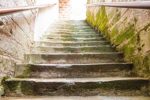 Old marble staircase stairway with moss stone steps