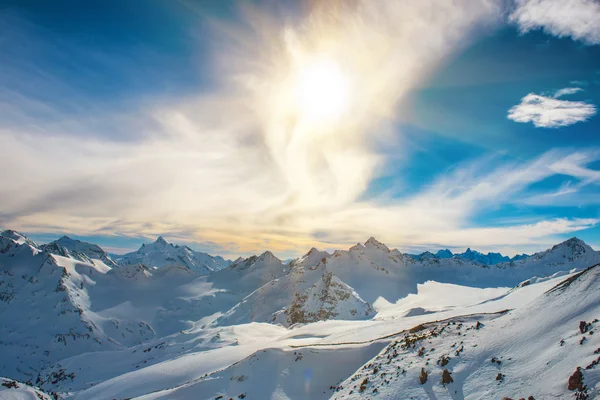 Snowy blue mountains in clouds — Stock Photo, Image