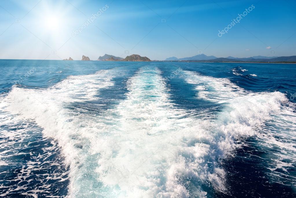 Waves on blue sea over speed boat