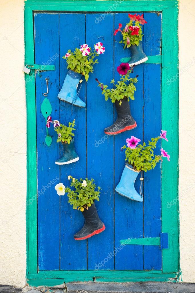 Old rubber boots with blooming flowers — Stock Photo © dovapi 80562092