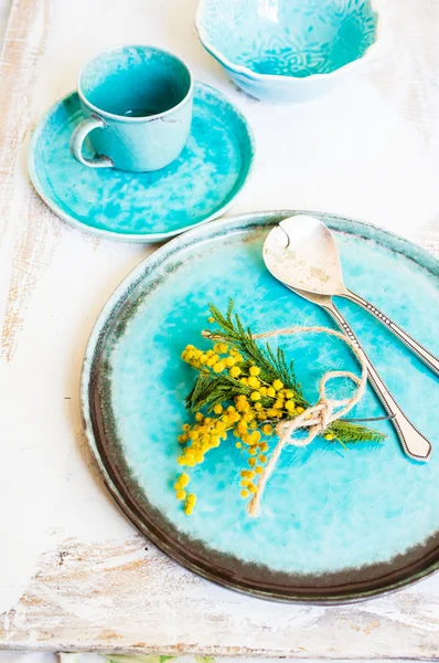 Table setting with sprig mimosa flowers — Stock Photo, Image