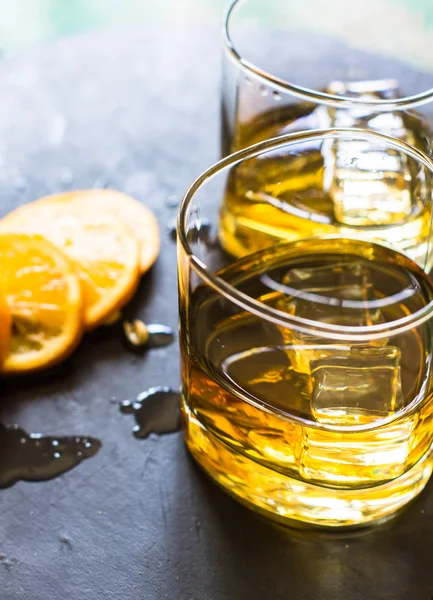 Glass of wiskey, lemon and ice — Stock Photo, Image