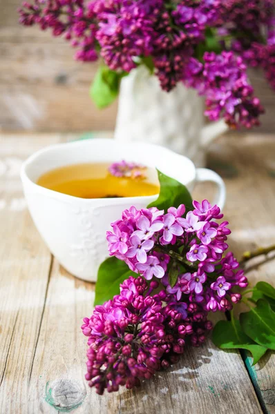 Lilac flowers in a rustic interior — Stock Photo, Image