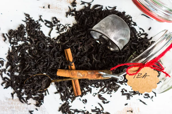 Black tea leaves on rustic background — Stock Photo, Image