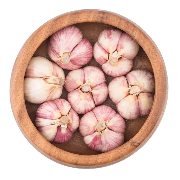 Garlic on wooden bowl top view of white background — Stock Photo, Image