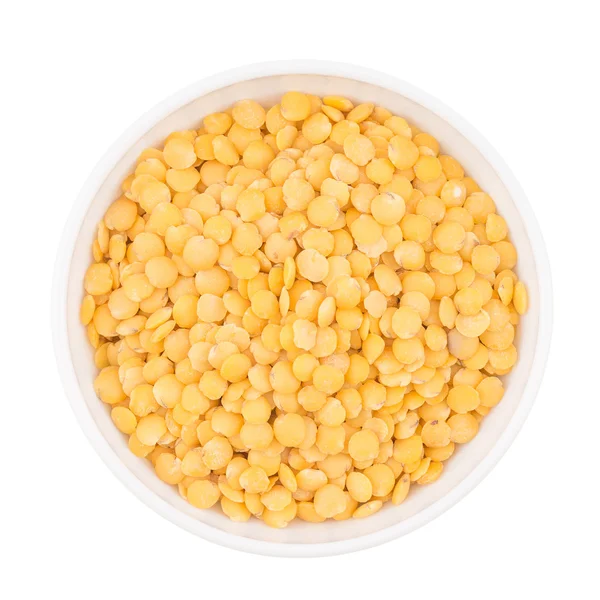 Bowl of yellow split lentil isolated on white background, top vi — Stock Photo, Image