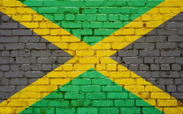 Flag of Jamaica painted on brick wall, background texture — Stock Photo, Image