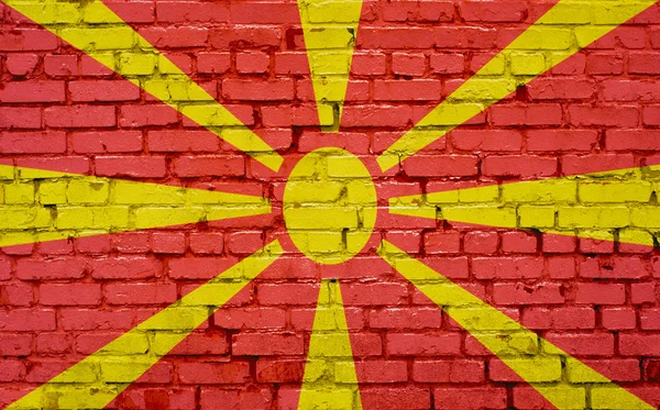 Flaga Macedonii malowane na mur z cegły, tekstury tło — Zdjęcie stockowe