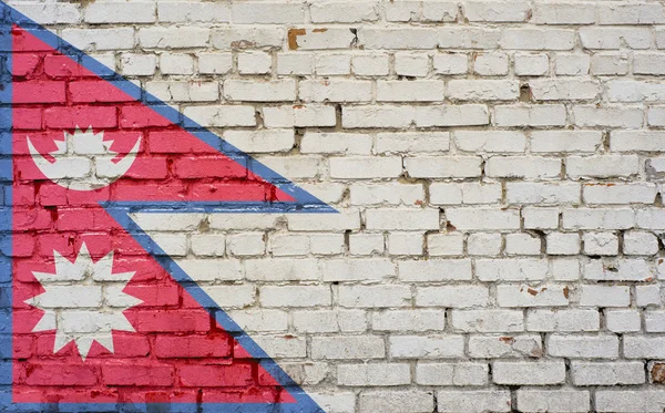 Drapeau du Népal peint sur un mur de briques, texture de fond — Photo