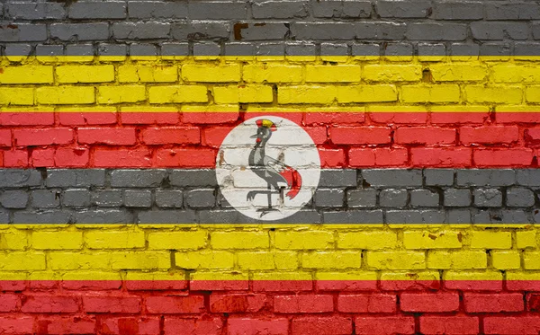 Drapeau de l'Ouganda peint sur un mur de briques, texture de fond — Photo