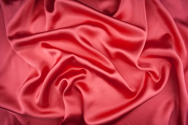 Red satin or silk fabric as background — Stock Photo, Image