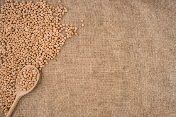 Dried white chickpeas ceci on sack. Top view. — Stock Photo, Image