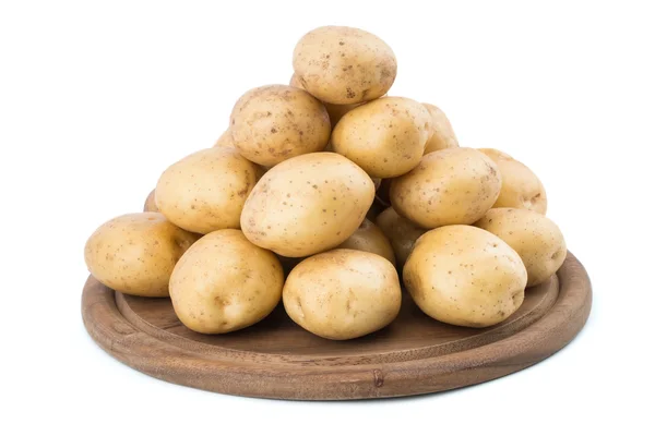 Young potatoes on a cutting board on white background close-up. — Stock Photo, Image