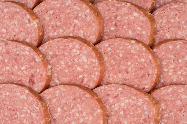 Salami background with many sliced pieces of salami — Stock Photo, Image