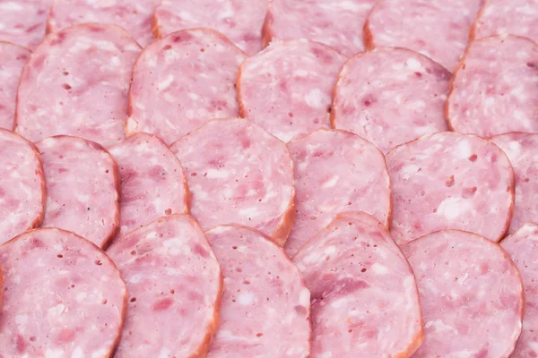 Slices of salami on salami background. — Stock Photo, Image