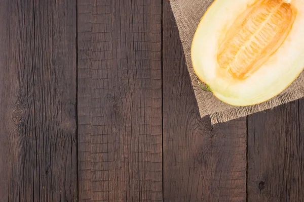 Melon on an old wooden table — Stock Photo, Image