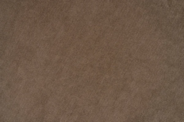 Natural fabric of brown color. Close-up long and wide texture of natural fabric. Fabric texture of natural cotton or linen textile material. Top view.