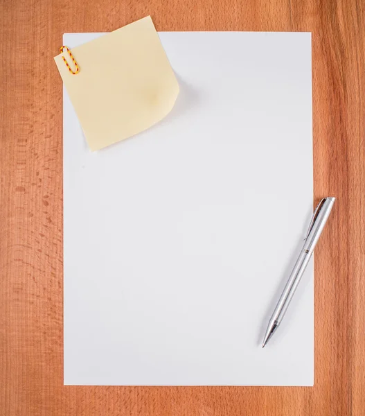Blank white paper with pen on a wooden desk. — Stock Photo, Image