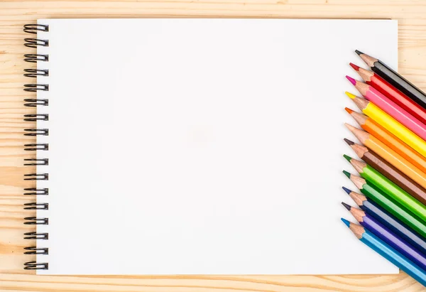 Blank paper and colorful pencils on the wooden table. View from Royalty Free Stock Photos